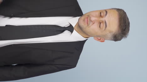 Vertical-video-of-Stressed-businessman-loosens-his-tie.